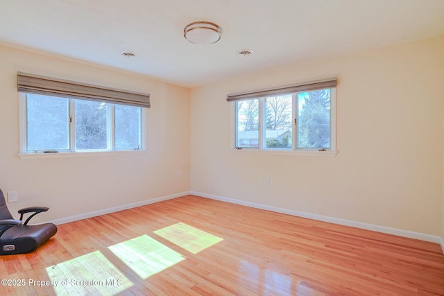 empty room with wood finished floors and baseboards