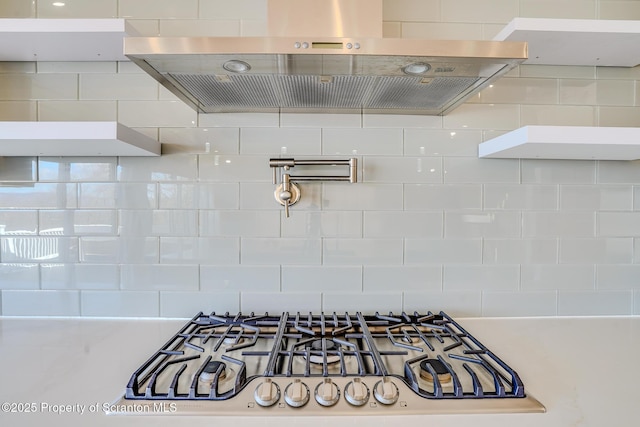 details with stainless steel gas stovetop and island exhaust hood