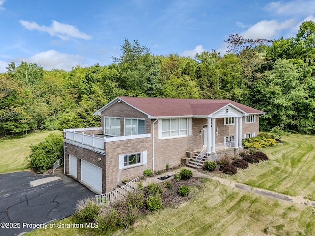 100 Marjorie Dr, Scranton, PA 18505 - raised ranch with asphalt driveway, brick siding, and a wooded view