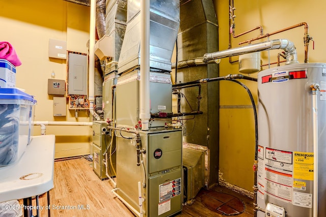 utility room featuring electric panel and gas water heater