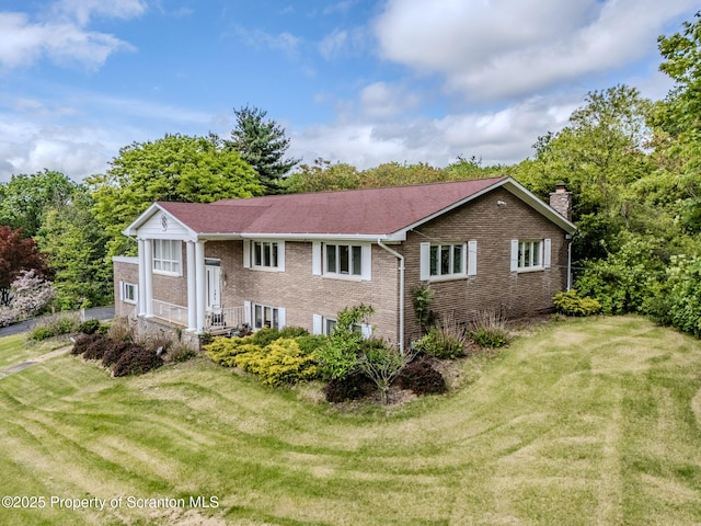 100 Marjorie Dr, Scranton, PA 18505 - view of front of property featuring brick siding, a chimney, and a front lawn