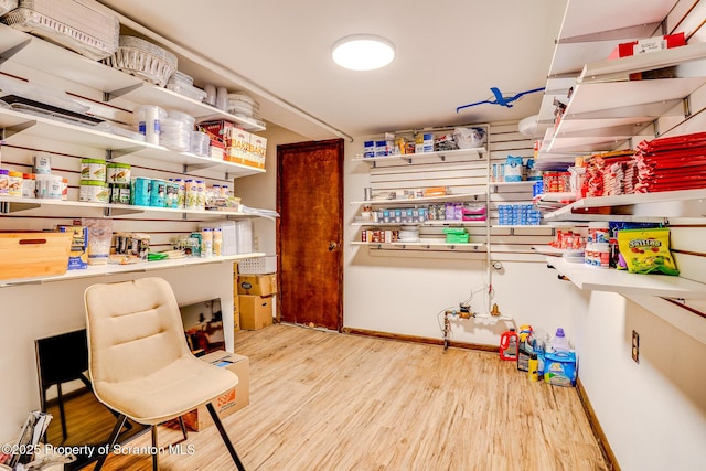 interior space with baseboards and wood finished floors