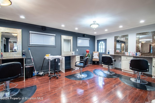 office space featuring built in desk, wood-type flooring, and crown molding