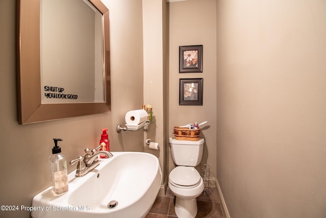 bathroom featuring sink, tile patterned flooring, and toilet