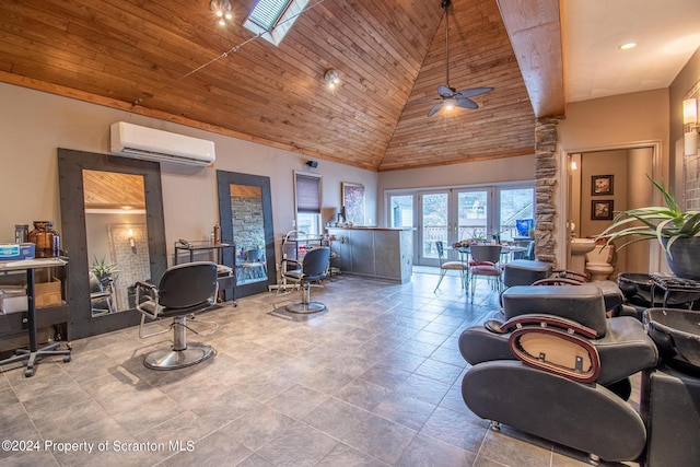 interior space featuring a wall mounted air conditioner, a skylight, wood ceiling, ceiling fan, and high vaulted ceiling