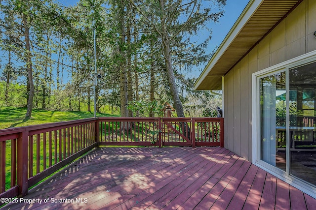 wooden deck with a lawn