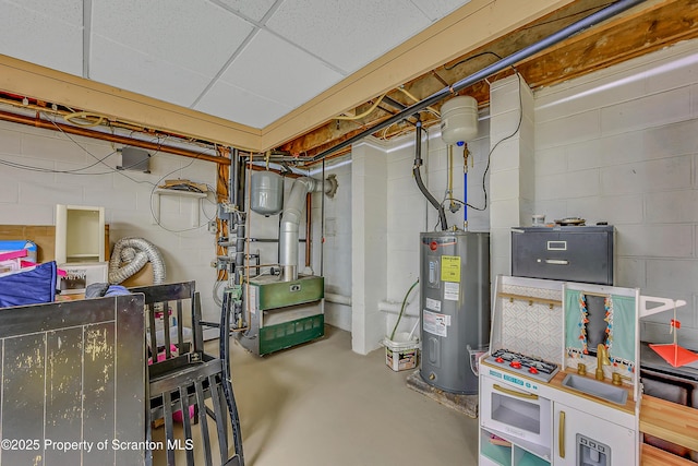 unfinished basement featuring concrete block wall, a heating unit, and water heater