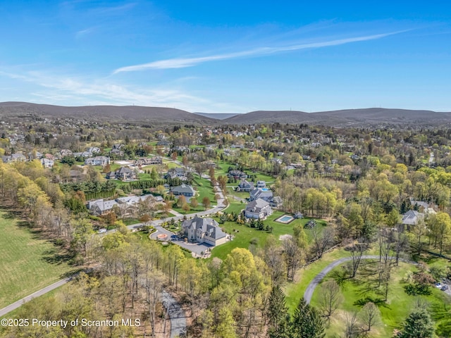 drone / aerial view featuring a residential view and a mountain view