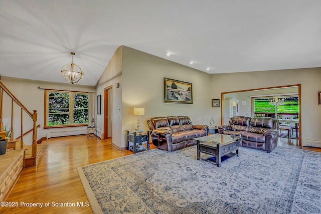 living area featuring stairs, wood finished floors, a baseboard radiator, an inviting chandelier, and recessed lighting
