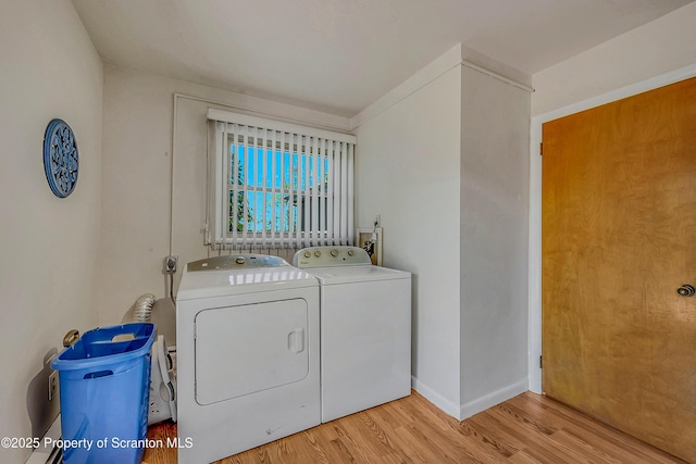 washroom featuring laundry area, light wood-style flooring, baseboards, and washer and dryer