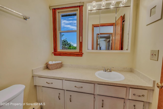 bathroom featuring vanity and toilet