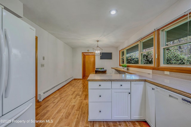 kitchen with a baseboard radiator, white cabinets, a notable chandelier, white appliances, and light wood-style flooring