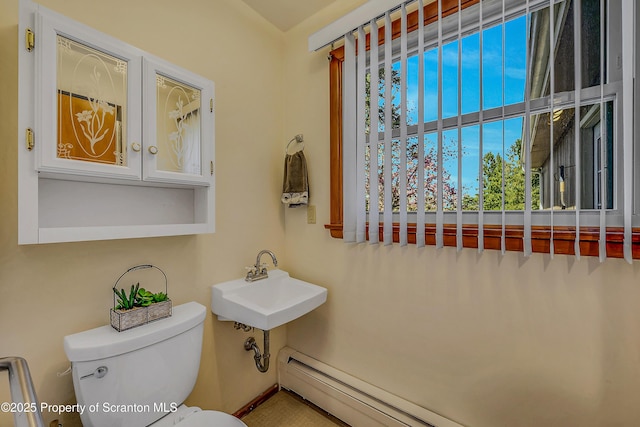 bathroom with a baseboard radiator, a sink, and toilet