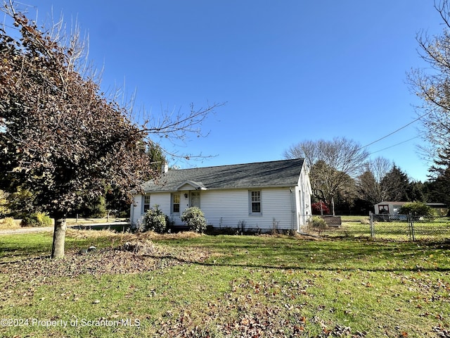 view of property exterior featuring a lawn