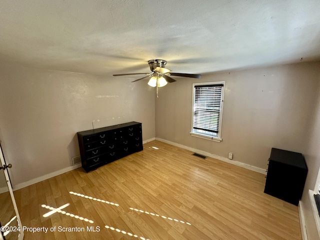 unfurnished bedroom featuring ceiling fan and light hardwood / wood-style floors