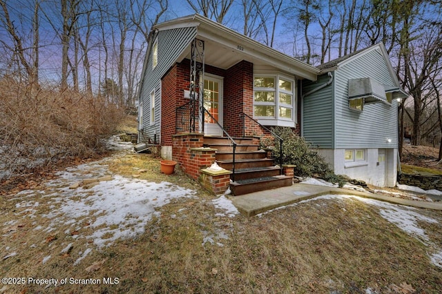 view of front of property with entry steps and brick siding