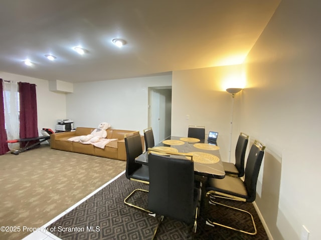 dining area with dark colored carpet