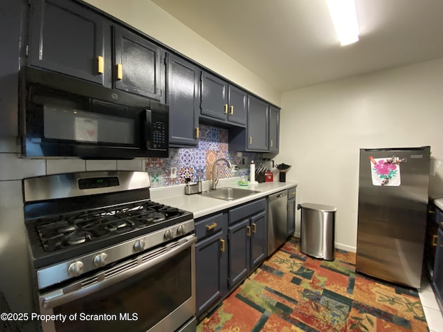 kitchen with a sink, baseboards, light countertops, appliances with stainless steel finishes, and decorative backsplash