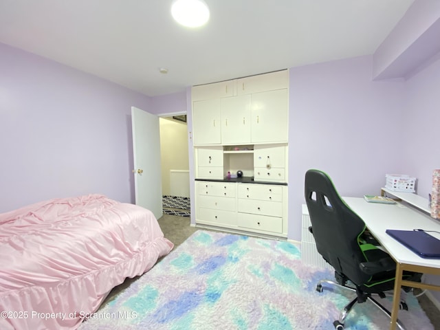 bedroom with a closet and light colored carpet