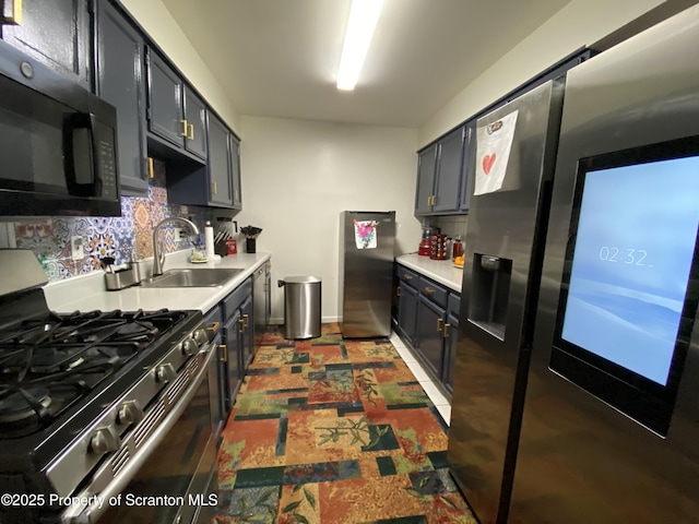 kitchen featuring a sink, decorative backsplash, stainless steel appliances, and light countertops