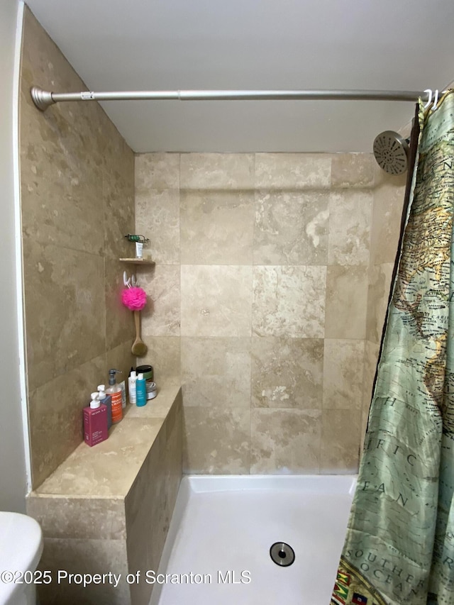 bathroom with a tile shower