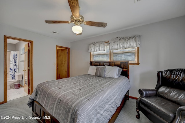 bedroom with connected bathroom, ceiling fan, and light carpet