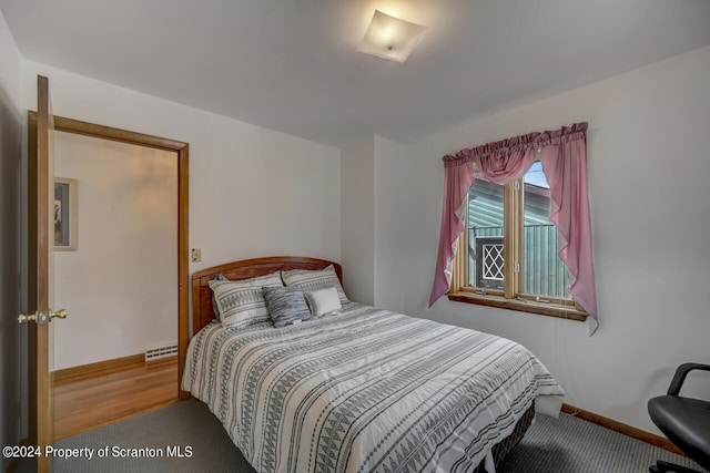 bedroom featuring carpet and baseboard heating