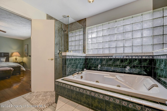 bathroom featuring tile patterned flooring and plus walk in shower