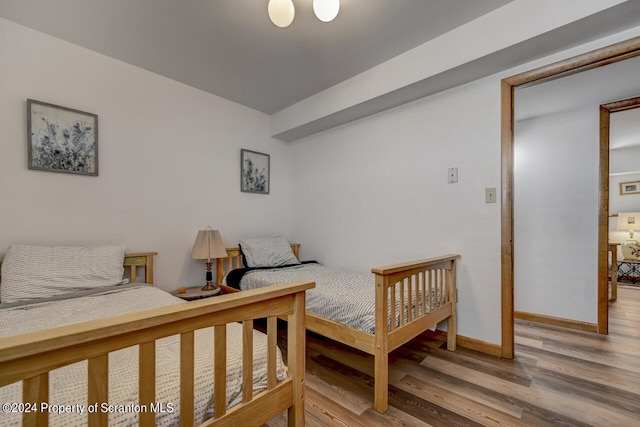 bedroom with wood-type flooring