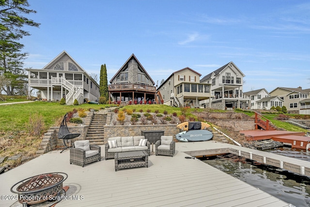 dock area with a wooden deck and an outdoor living space with a fire pit