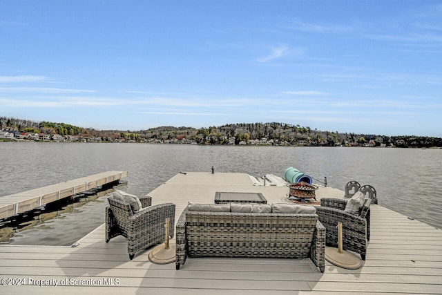 view of dock featuring outdoor lounge area and a water view