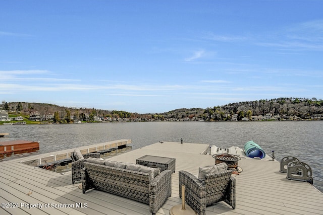 dock area featuring a water view and an outdoor fire pit