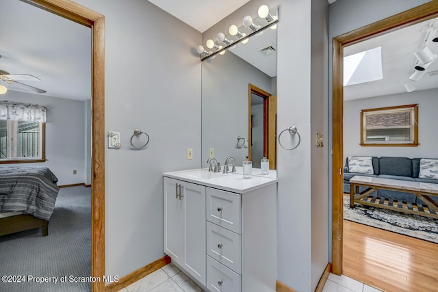 bathroom featuring tile patterned floors, ceiling fan, and vanity