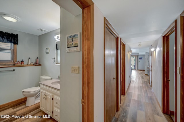 hall with sink and light hardwood / wood-style flooring