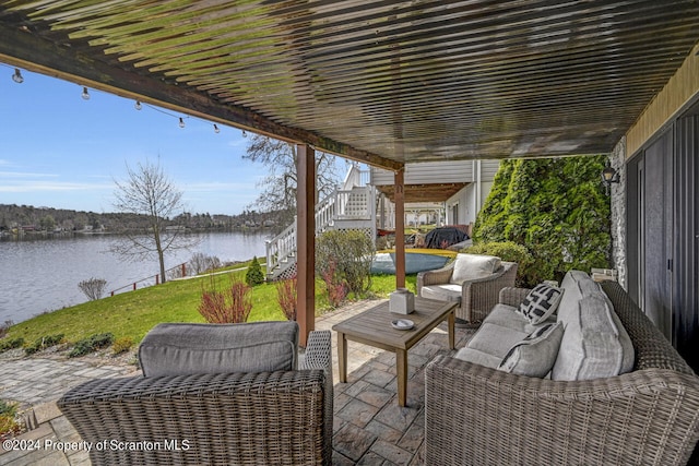 view of patio with outdoor lounge area and a water view