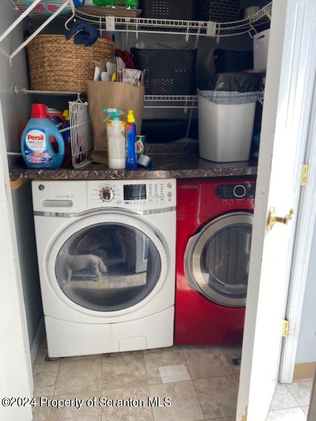 clothes washing area with independent washer and dryer