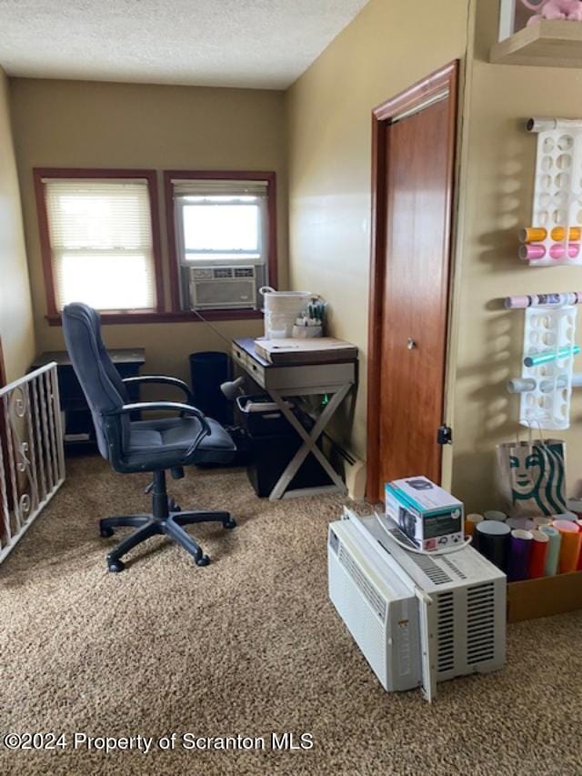 carpeted office space featuring a textured ceiling and cooling unit