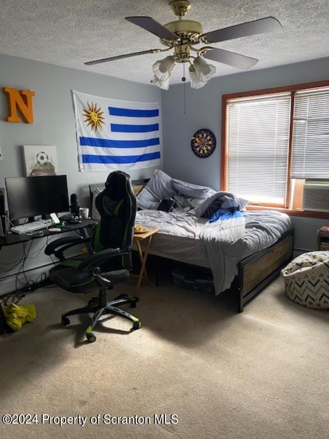 bedroom with ceiling fan, cooling unit, carpet floors, and a textured ceiling