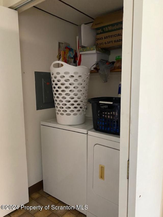 laundry room with washing machine and dryer and electric panel