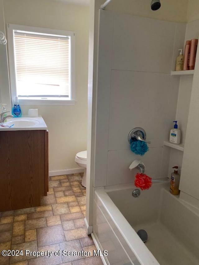 full bathroom featuring vanity, shower / bath combination, and toilet