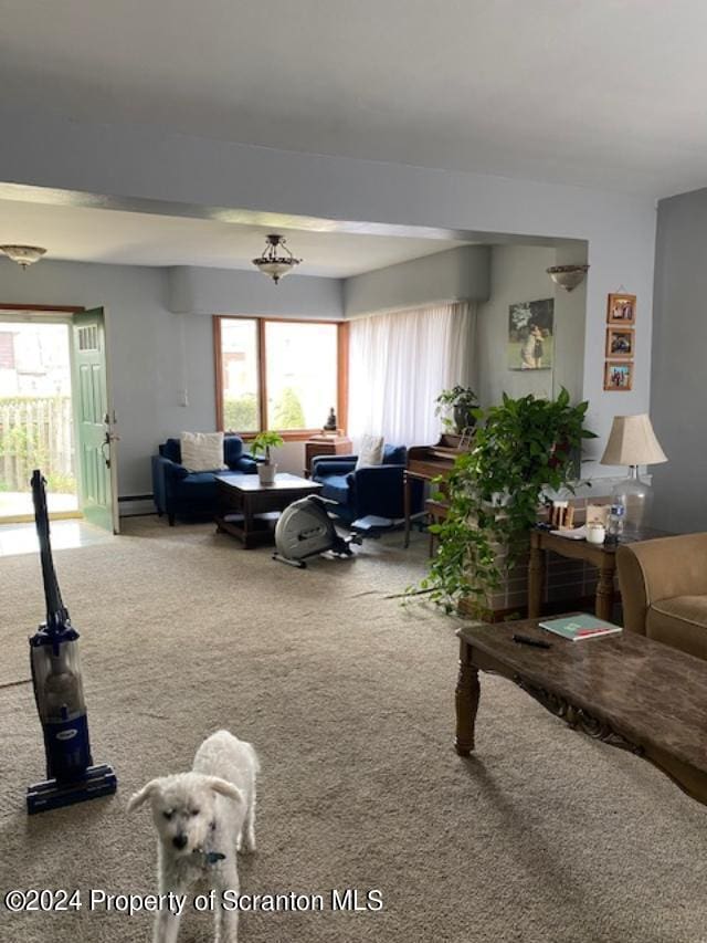 carpeted living room with baseboard heating