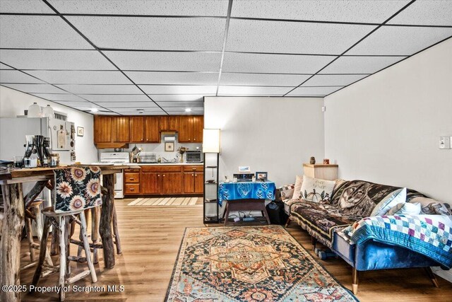 180 E Shore Dr, Dingmans Ferry, PA 18328 - living room with light wood-style floors, a paneled ceiling, and a toaster
