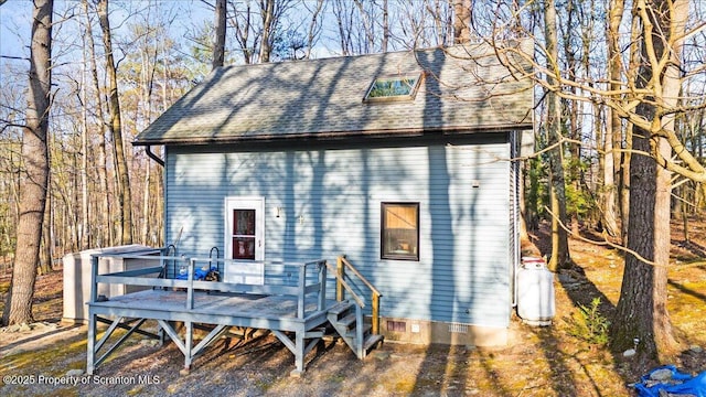 180 E Shore Dr, Dingmans Ferry, PA 18328 - rear view of property featuring crawl space, a wooden deck, and a shingled roof