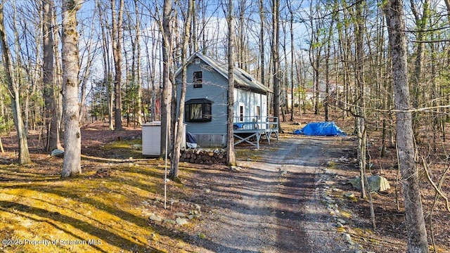 180 E Shore Dr, Dingmans Ferry, PA 18328 - view of front of property featuring a wooden deck and aphalt driveway