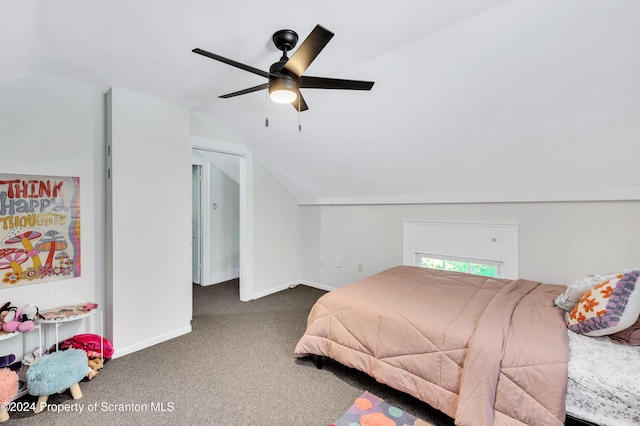 bedroom featuring dark carpet, vaulted ceiling, and ceiling fan