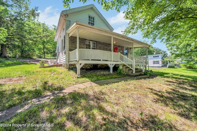 view of front of house with covered porch and a front yard