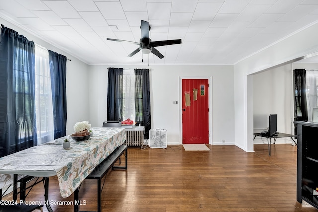 dining area with plenty of natural light, dark hardwood / wood-style floors, crown molding, and ceiling fan