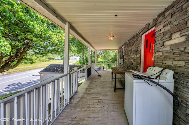 view of patio with washer / clothes dryer and a porch