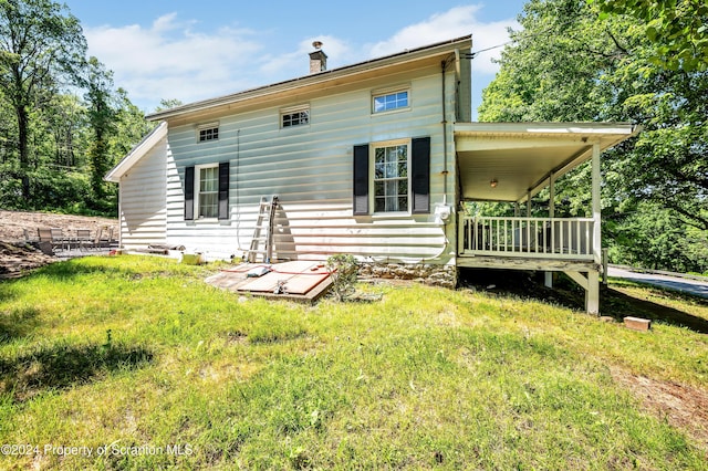 back of house with a yard