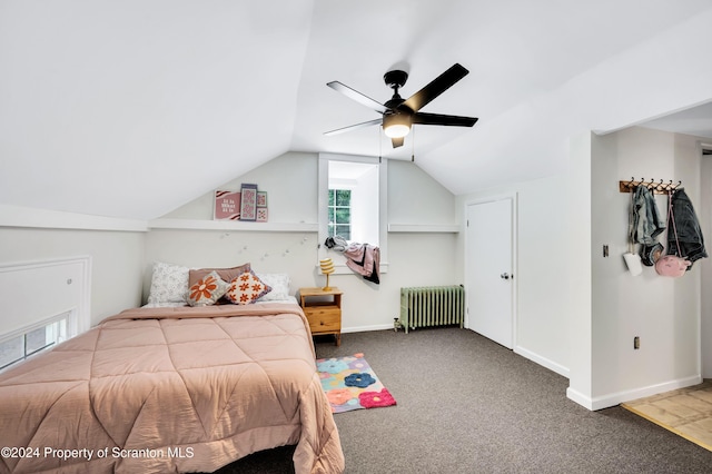 bedroom with ceiling fan, radiator heating unit, carpet, and vaulted ceiling